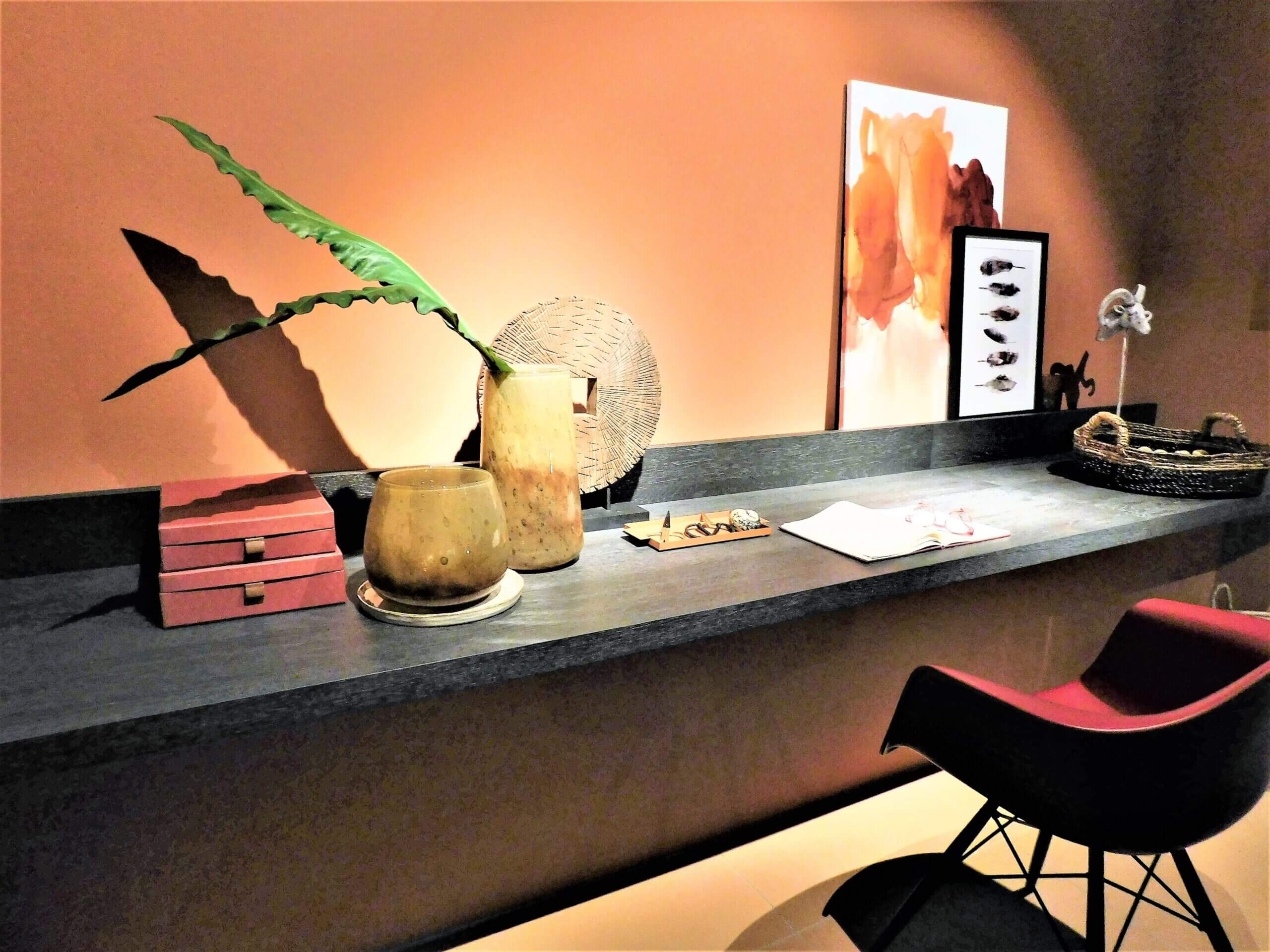 Full length wall desk with vase and notebook